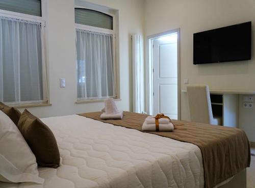 a bedroom with a large bed with a television on the wall at Bowen, Luxury Suites in Lagos