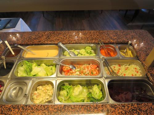 a tray of food on a counter with vegetables at Gasthof Einhaus in Borken
