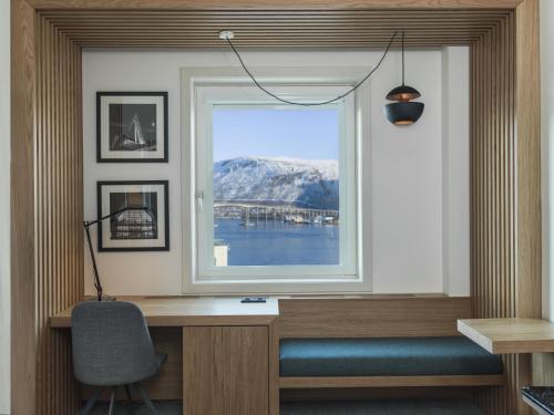 a window in a room with a desk and a chair at Radisson Blu Hotel Tromsø in Tromsø