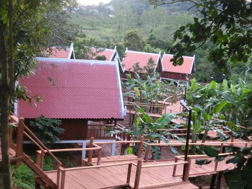 a row of houses with pink roofs at Greenhouse Retreat in Sen Monorom