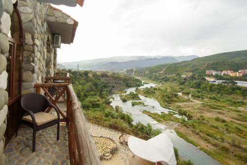 a balcony with a view of a river at Golden Fleece in Mtskheta