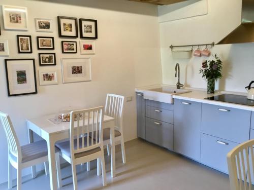 a kitchen with a table and chairs and a sink at La Pergola B&B in Cesena