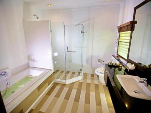 a bathroom with a shower and a toilet and a sink at Smile House - SHA Extra Plus in Bophut