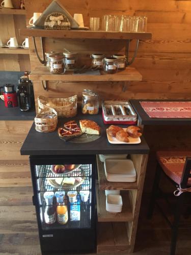 an open refrigerator with food on a table at B&B San Sebastiano in Vernante
