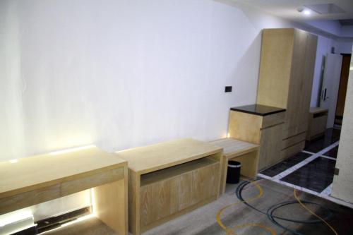 a room with wooden desks in a room at Melian Hotel in An Najaf