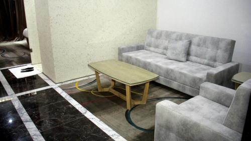 a living room with a couch and a table at Melian Hotel in An Najaf