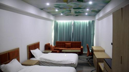 a hotel room with two beds and a couch at Melian Hotel in An Najaf