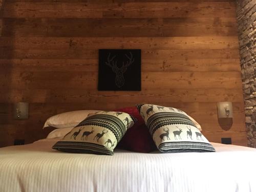 a bedroom with a bed with pillows on it at B&B San Sebastiano in Vernante
