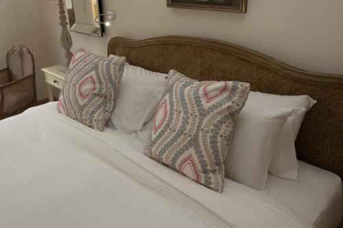 a bed with white pillows and white sheets at Carlton Towers Stapleton's & Parkgate's in Carlton
