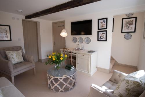 a living room with a vase of flowers on a table at Carlton Towers Stapleton's & Parkgate's in Carlton