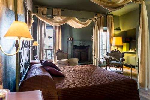 a bedroom with a bed with a canopy at Antico Borgo B&B con SPA - Adults Only in Manerba del Garda