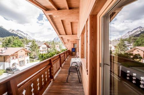 a balcony with a view of the mountains at Garni Hotel Residence Diamant in San Vigilio Di Marebbe