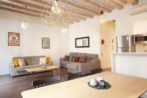 ein Wohnzimmer mit einem Sofa und einem Tisch in der Unterkunft Rent Top Apartments near Plaza de Catalunya in Barcelona