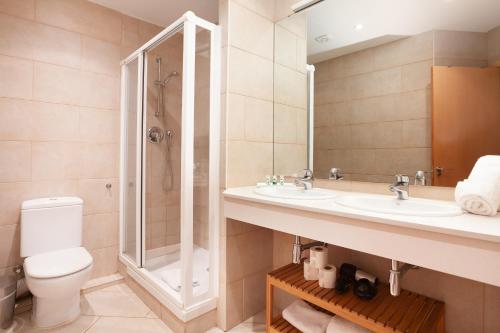 a bathroom with a toilet and a sink and a shower at Rent Top Apartments near Plaza de Catalunya in Barcelona