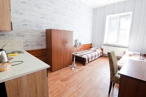 a bedroom with a bed and a desk at Tsentr Hostel in Vinnytsya