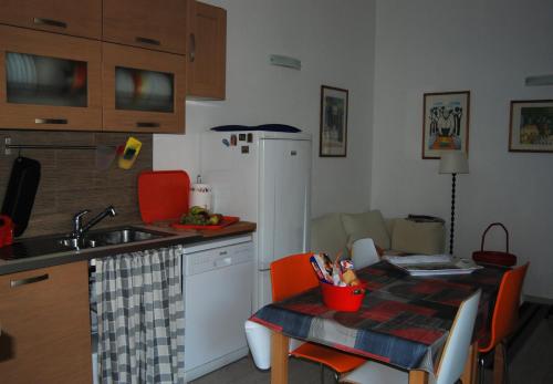 a kitchen with a sink and a table with a tableablish at Casa dolce casa in Viareggio