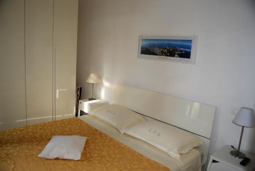 a bedroom with a bed and a picture on the wall at Casa dolce casa in Viareggio