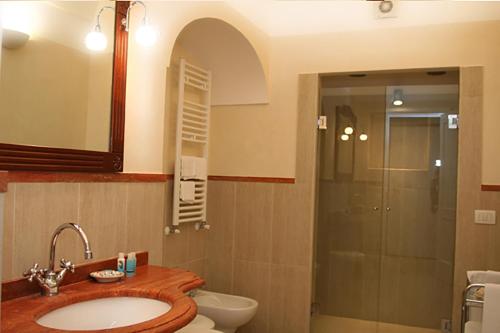 a bathroom with a sink and a shower at Palazzo Iaquinto in Santa Maria di Castellabate