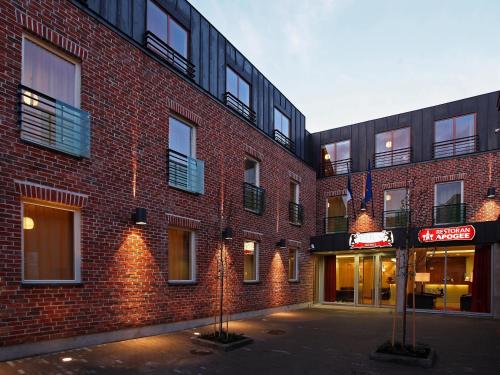 a brick building with a sign in front of it at Bern Boutique by Rikas Hotels in Tallinn