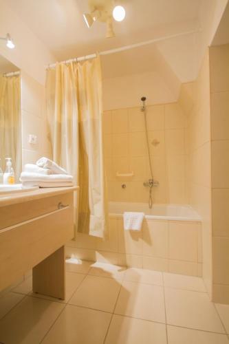 a bathroom with a sink and a tub and a shower at Corum in Karpacz