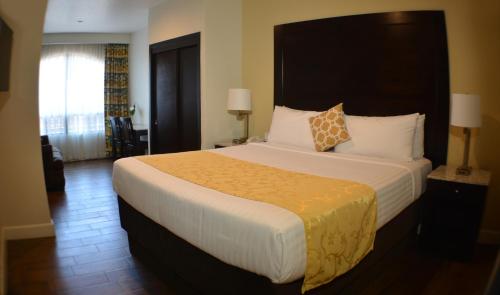 a bedroom with a large bed with a large headboard at Hotel America in Tijuana