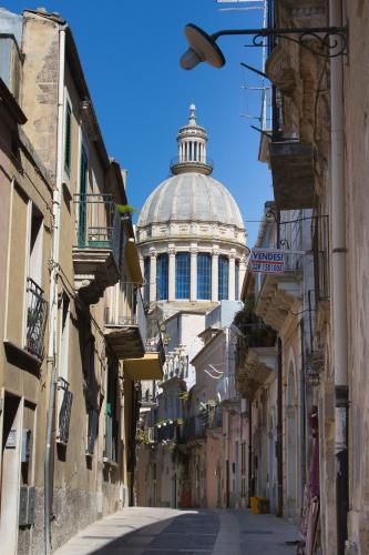 a street with a building with a dome at Tocco Barocco - Locazioni Brevi - in Ragusa