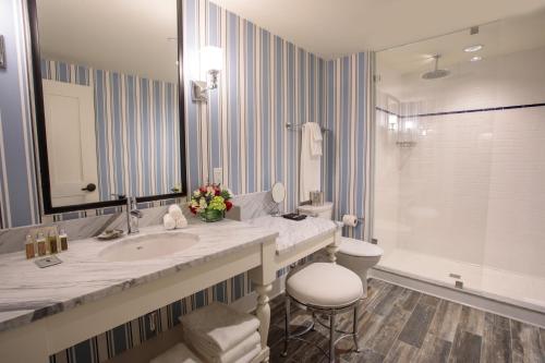 a bathroom with a sink and a toilet and a mirror at Beauport Hotel Gloucester in Gloucester