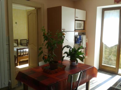 a dining room with a table with plants on it at la maison seillere in Senones