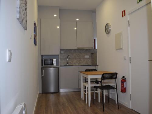 a kitchen with a table and chairs in a room at Oporto Living Apartments in Porto