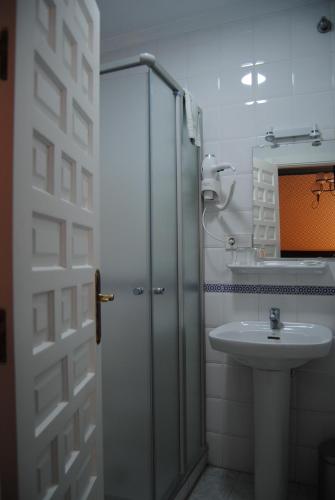 a bathroom with a shower and a sink at Pensión Córdoba in Seville