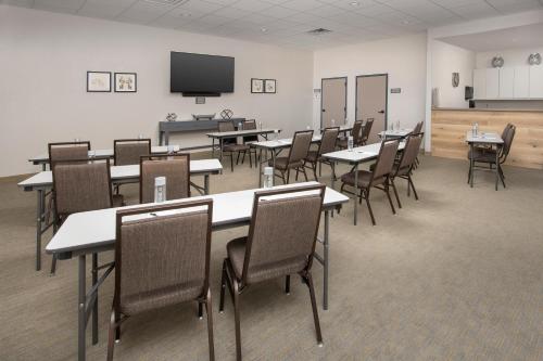 a classroom with tables and chairs and a flat screen tv at Country Inn & Suites by Radisson, Houston Intercontinental Airport East, TX in Humble