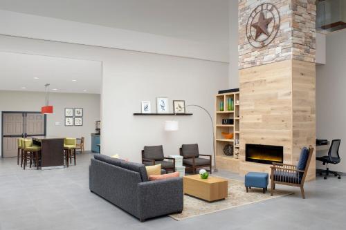 a living room with furniture and a fireplace at Country Inn & Suites by Radisson, Houston Intercontinental Airport East, TX in Humble