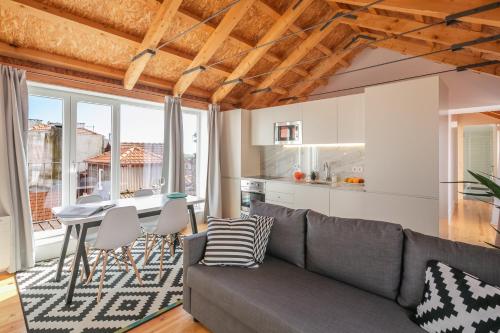 a living room with a couch and a table at Indulge Porto Flats in Porto