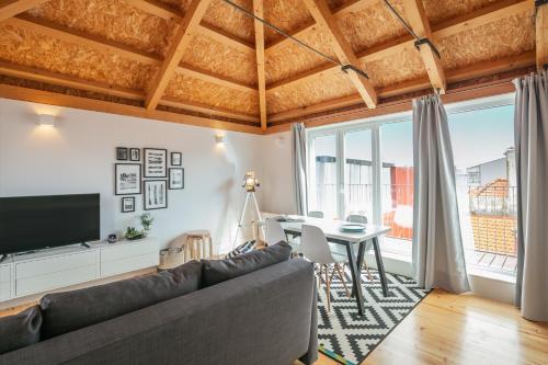 a living room with a couch and a table at Indulge Porto Flats in Porto