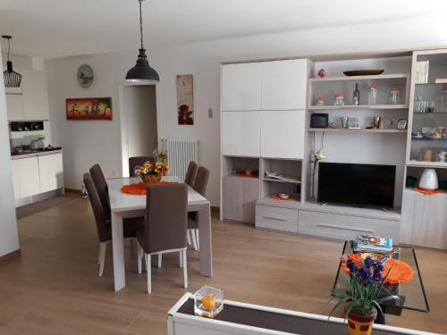 a kitchen and dining room with a table and a television at Green Park in Lecce