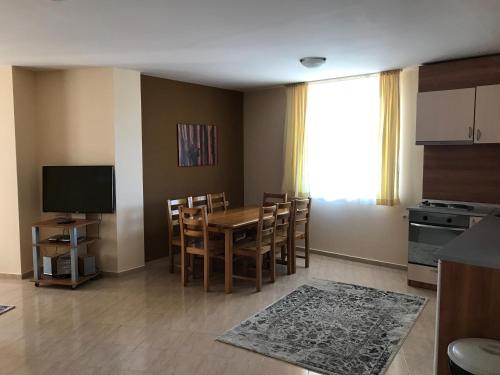 a kitchen and dining room with a table and chairs at Apartment Lucy in Pamporovo