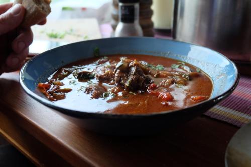 a bowl of soup on top of a table at Willa Pod Aniołem - Pokoje Gościnne & Apartamenty z widokiem na góry in Szczyrk