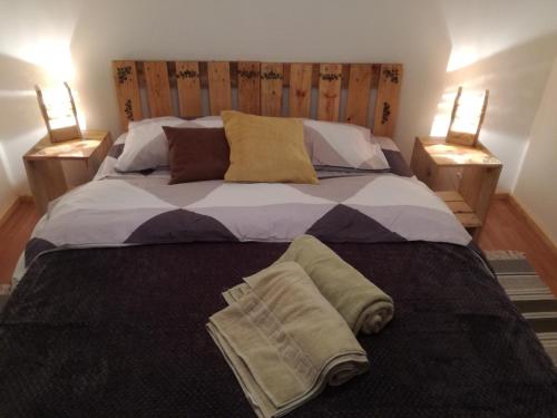 a bedroom with a large bed with two night stands at Hostal Mi Paz in Valparaíso