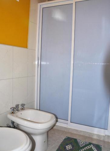 a bathroom with a shower and a toilet and a sink at Cabañas Las Golondrinas in Potrerillos