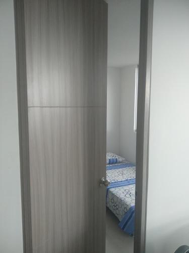 a door leading to a bedroom with a bed at Caffeto superstar 706 in Montenegro