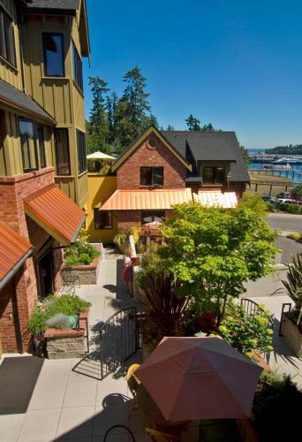 a patio with an umbrella in front of a building at The Eagle Harbor Inn in Winslow
