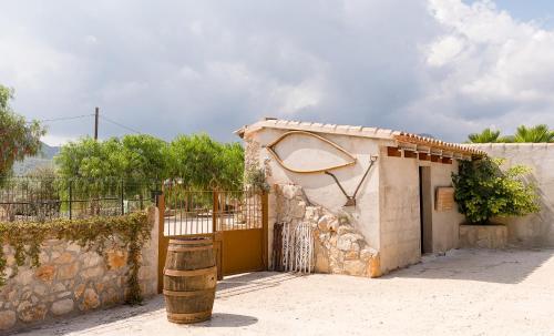 a small building with a gate and a fence at Marasolana in Jalón