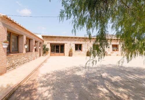 a brick building with a tree in front of it at Marasolana in Jalón