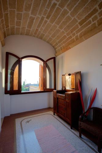 a living room with a couch and a window at Villa Le Macchie in Torre Vado