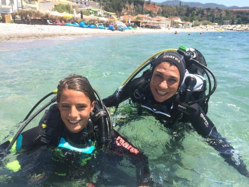 two people in the water in the ocean at AGALI 2 Superior Mezonet front of the sea in Akrogiali