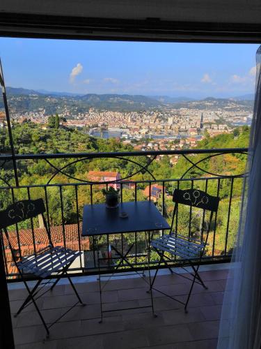 a table and chairs on a balcony with a view at Villa Patrizia in La Spezia