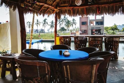 a blue table and chairs in a restaurant at Villa Santa Barbara in Barra de Navidad