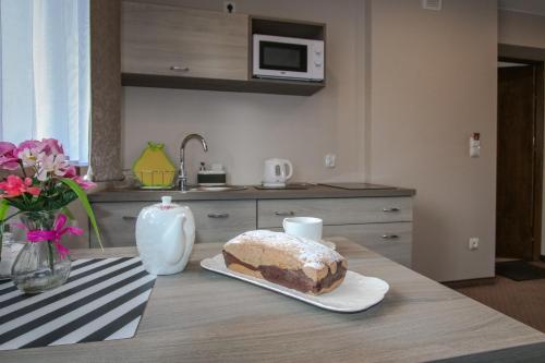 a cake sitting on a table in a kitchen at Ania Apartamenty in Chochołów