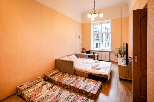 a room with two beds and a window at Old Riga Quiet Apartment in Riga
