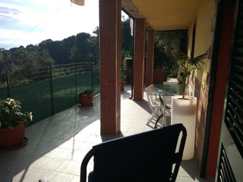 a balcony with a table and chairs on a house at Villa Patrizia in La Spezia